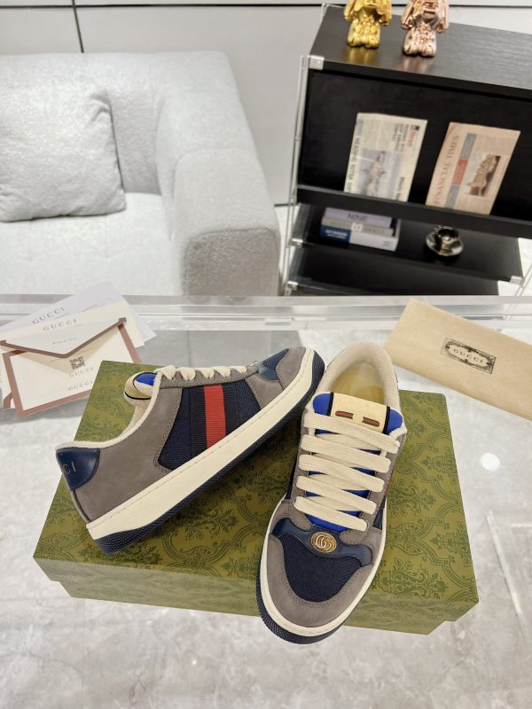 Low-top paneled suede and canvas sneakers in navy and gray.