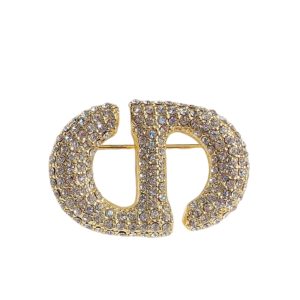 DIOR CD BROOCH GOLD WITH STONES ATTACHED